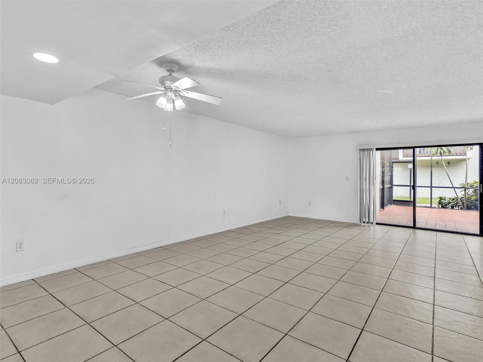 Living and Dining room combo with tile flooring and patio door slider
