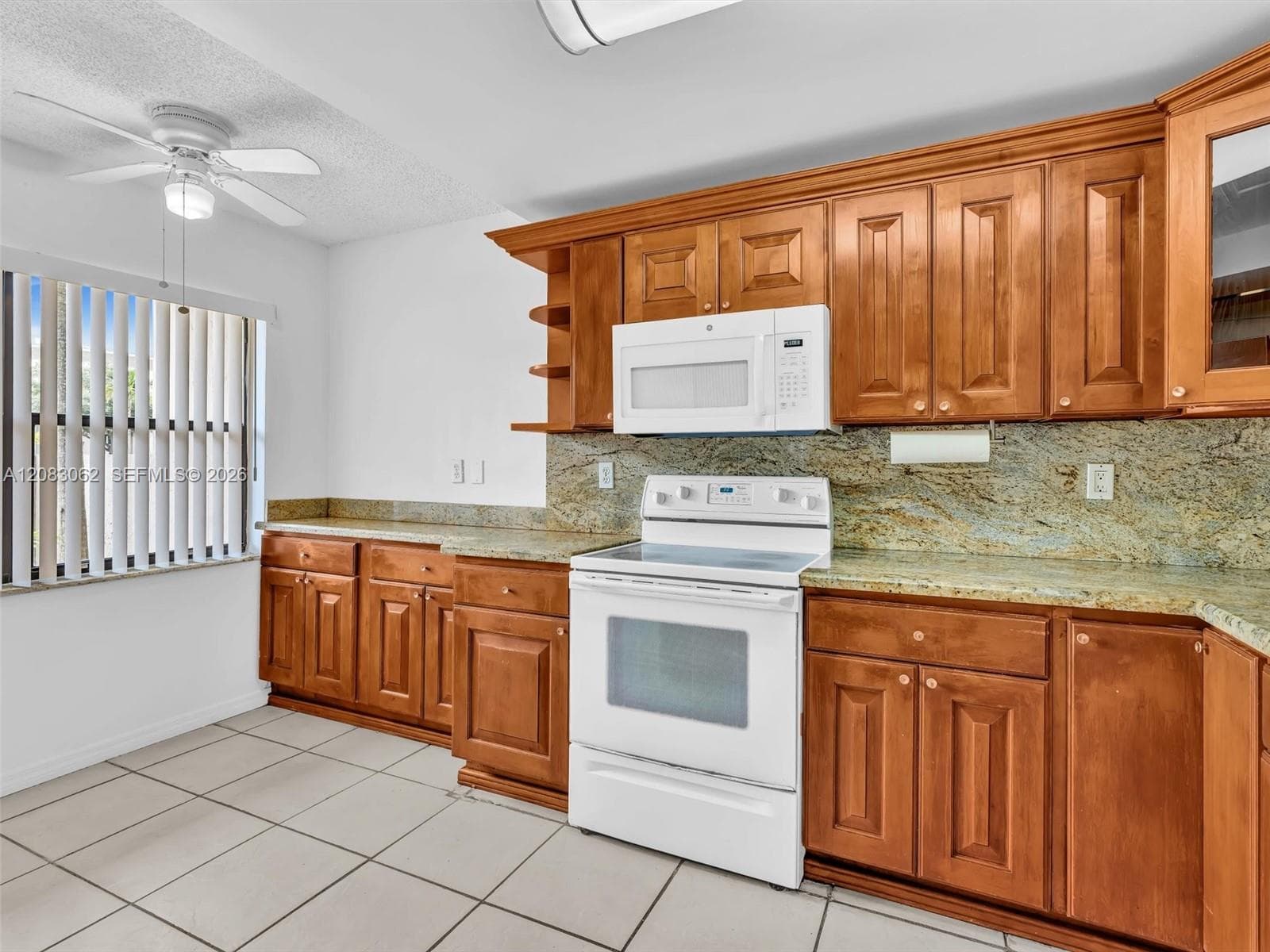 Ample Kitchen, Granite Counters, and huge window brings in natural light.