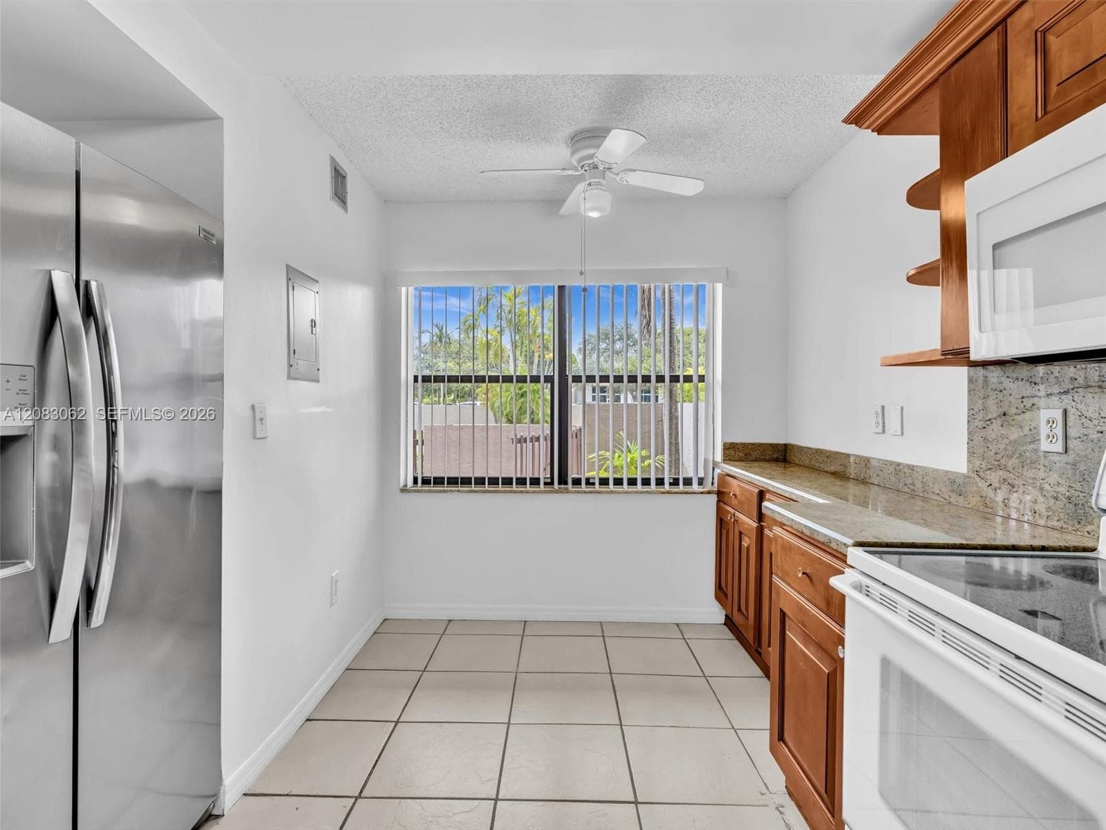 Ample Kitchen, Granite Counters, and huge window brings in natural light.