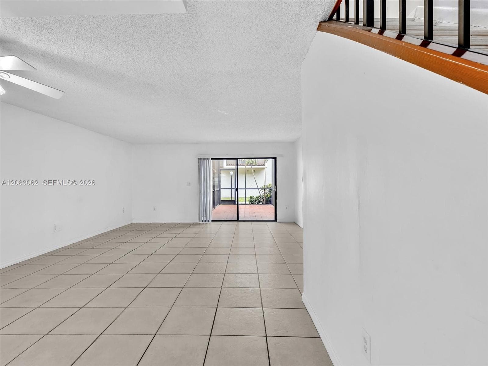 Living and Dining room combo with tile flooring and patio door slider
