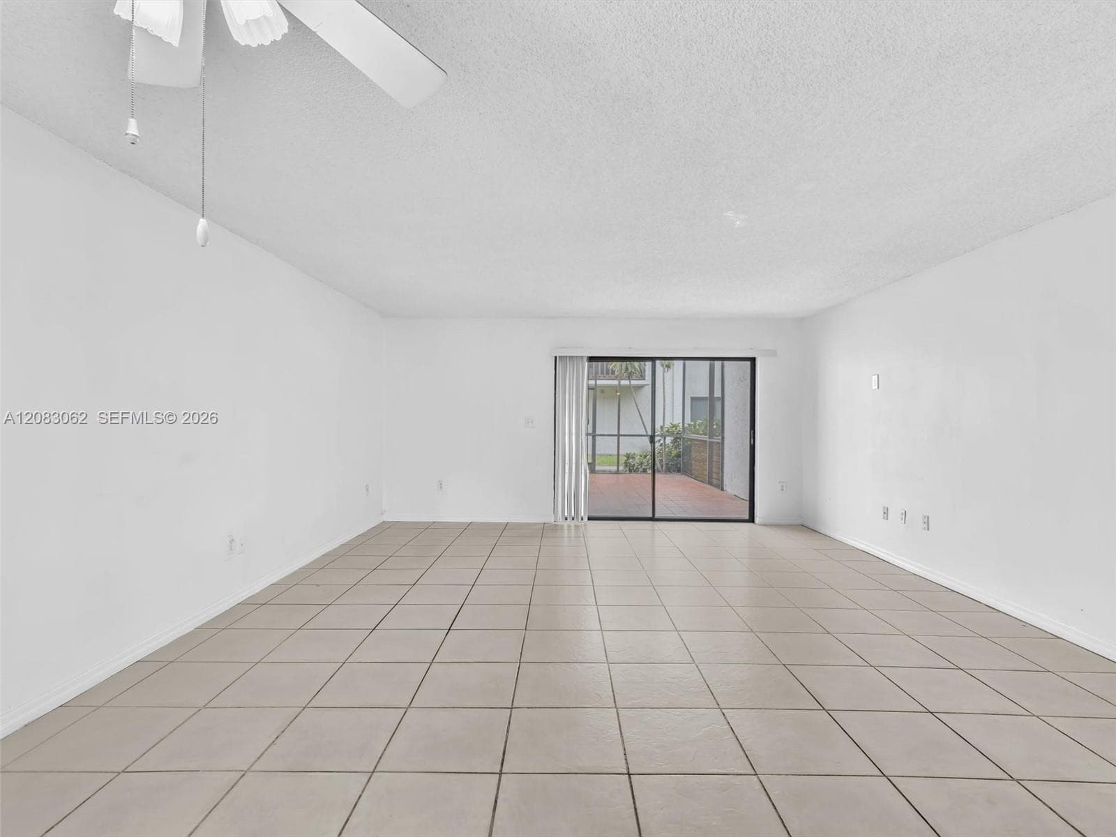 Living and Dining room combo with tile flooring and patio door slider