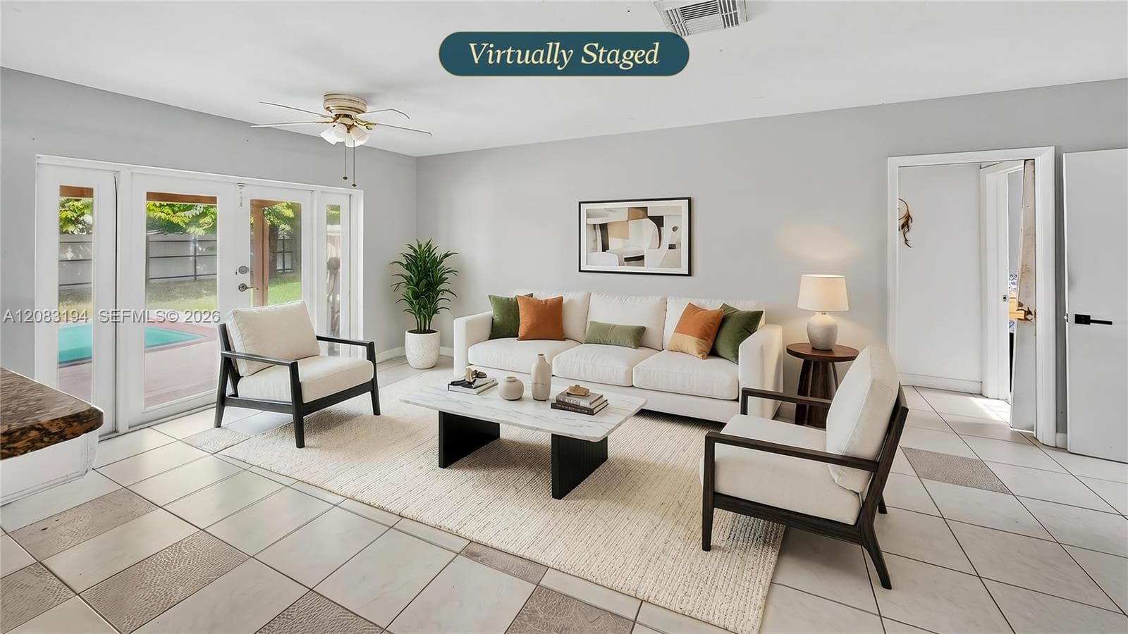 Living area featuring large-format ceramic tile flooring, neutral wall paint, and a ceiling-mounted fan with light fixture