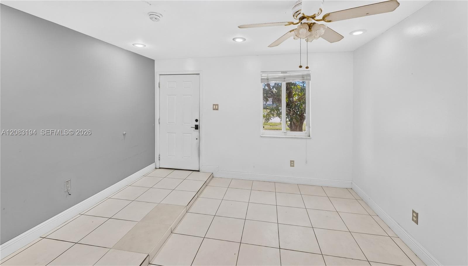 Interior space featuring neutral wall paint, tile flooring, recessed lighting, and a ceiling fan with light fixture