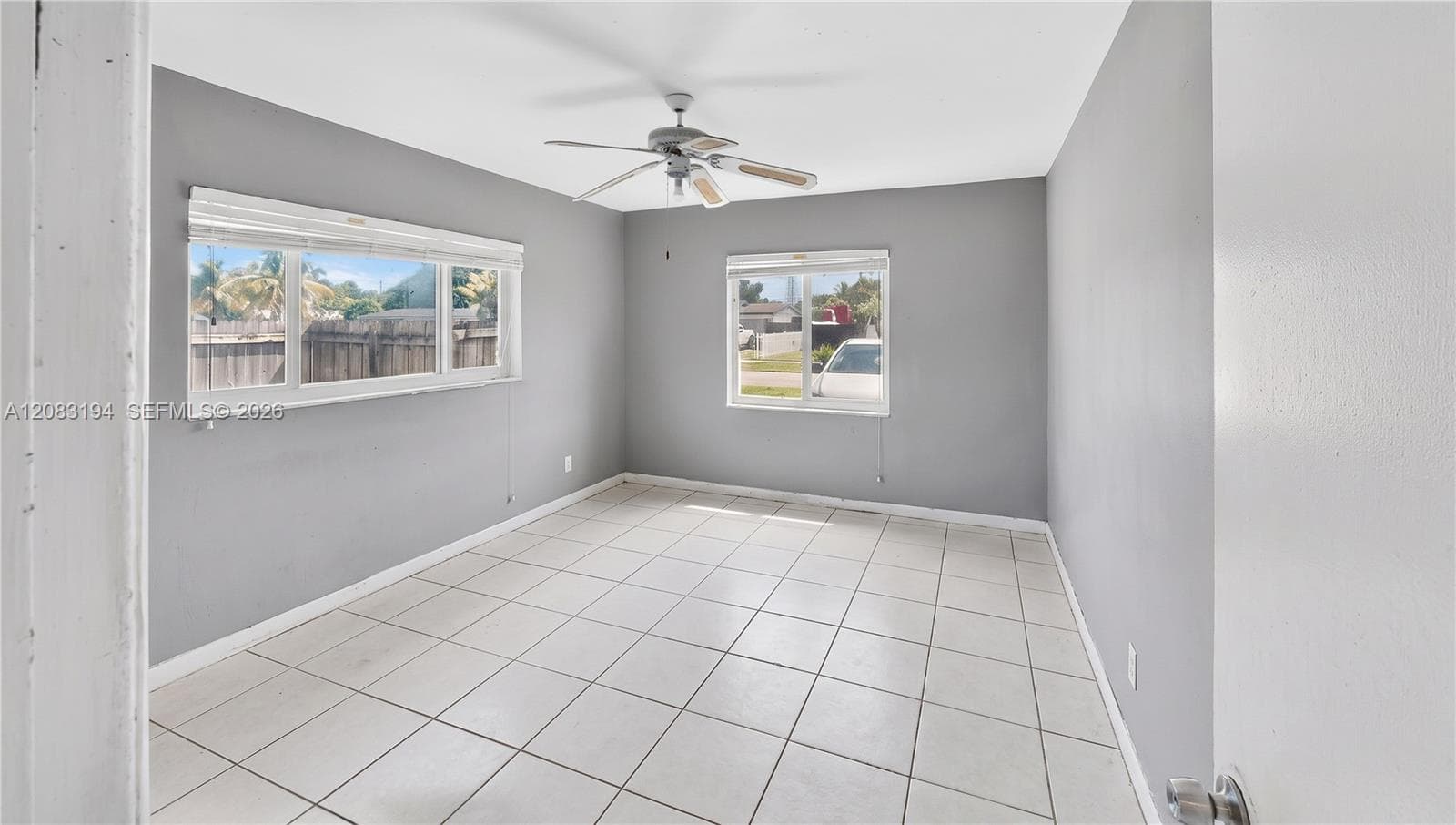 Neutral wall tones, ceramic tile flooring, dual-pane windows, and a ceiling fan