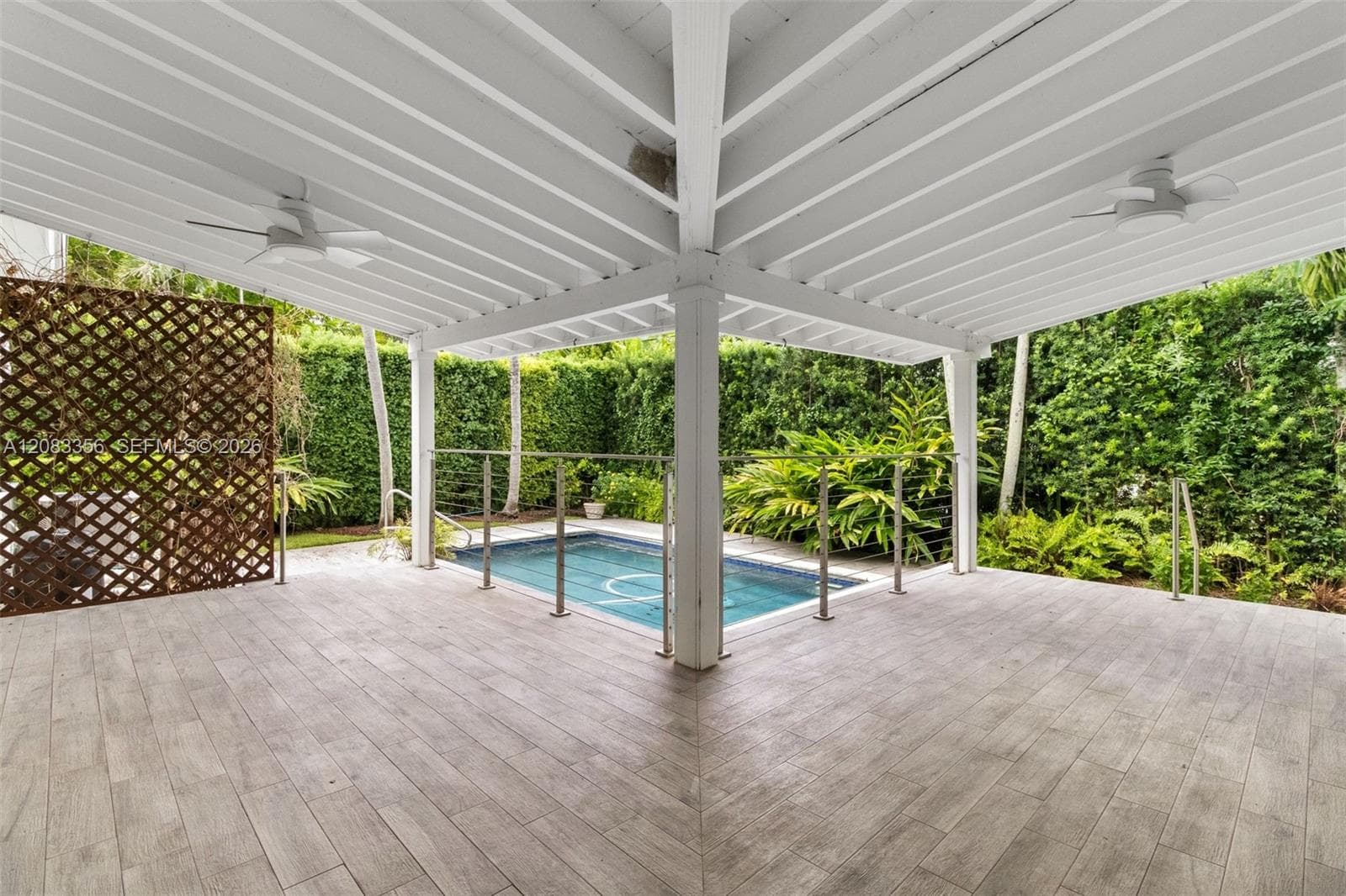 Expansive Tropical Pool Patio Entertainment Area