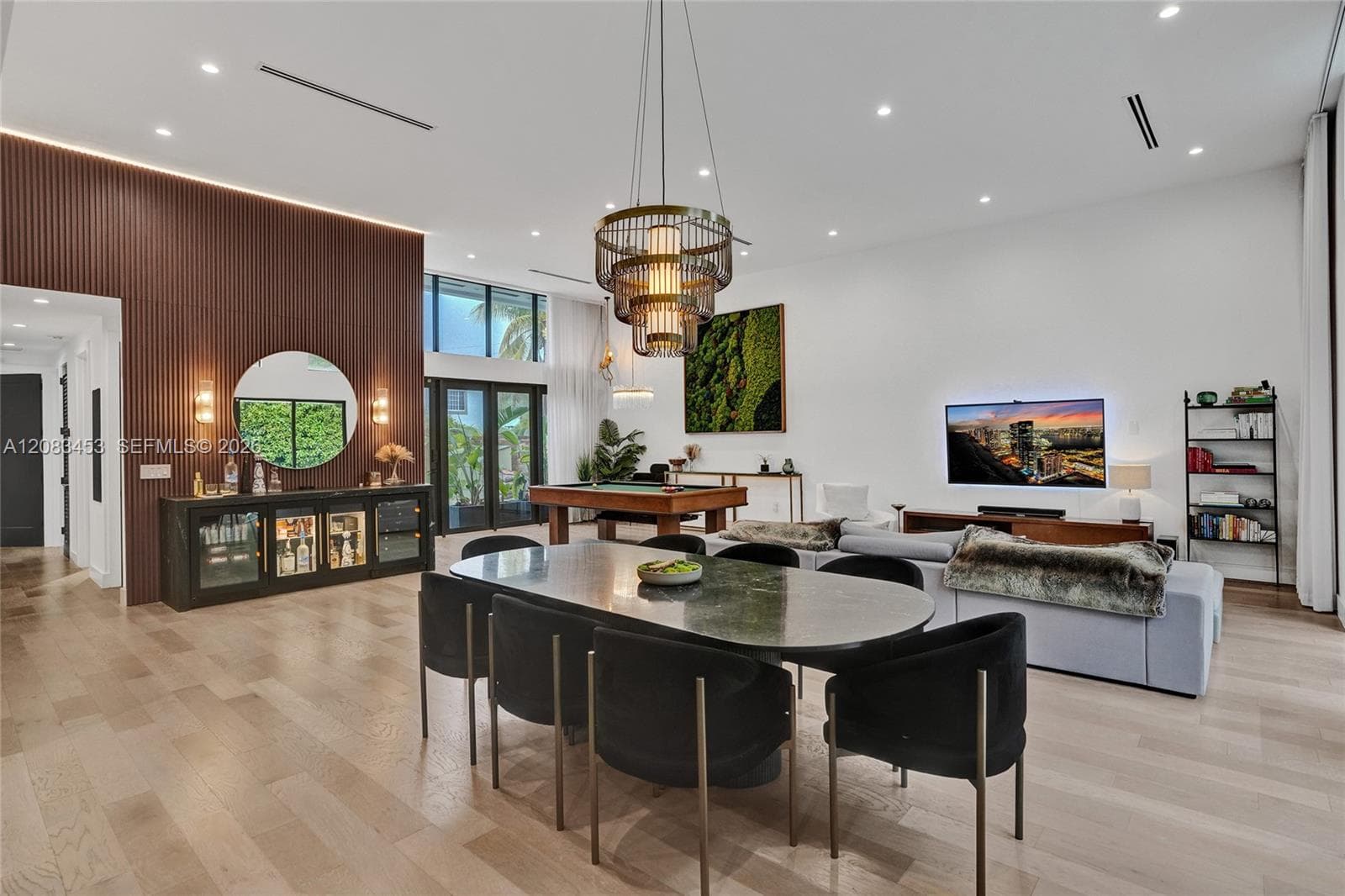 Open floor plan with stunning wood plank flooring and high ceilings.
