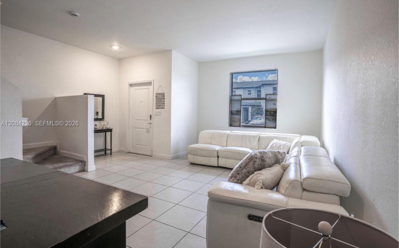 Ceramic tile flooring, neutral wall tones, and recessed lighting throughout