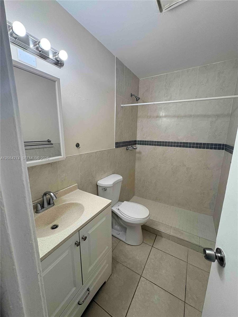 White vanity with brushed nickel hardware, integrated basin, and chrome faucet