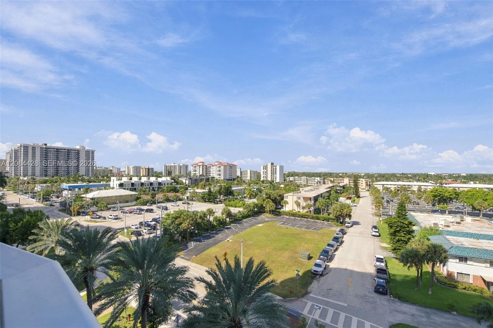 View from the balcony overlooking the Intracoastal, surrounding cityscape, and lush grounds.