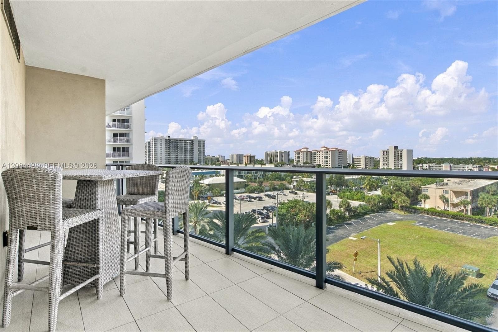 Expansive furnished balcony with a view.