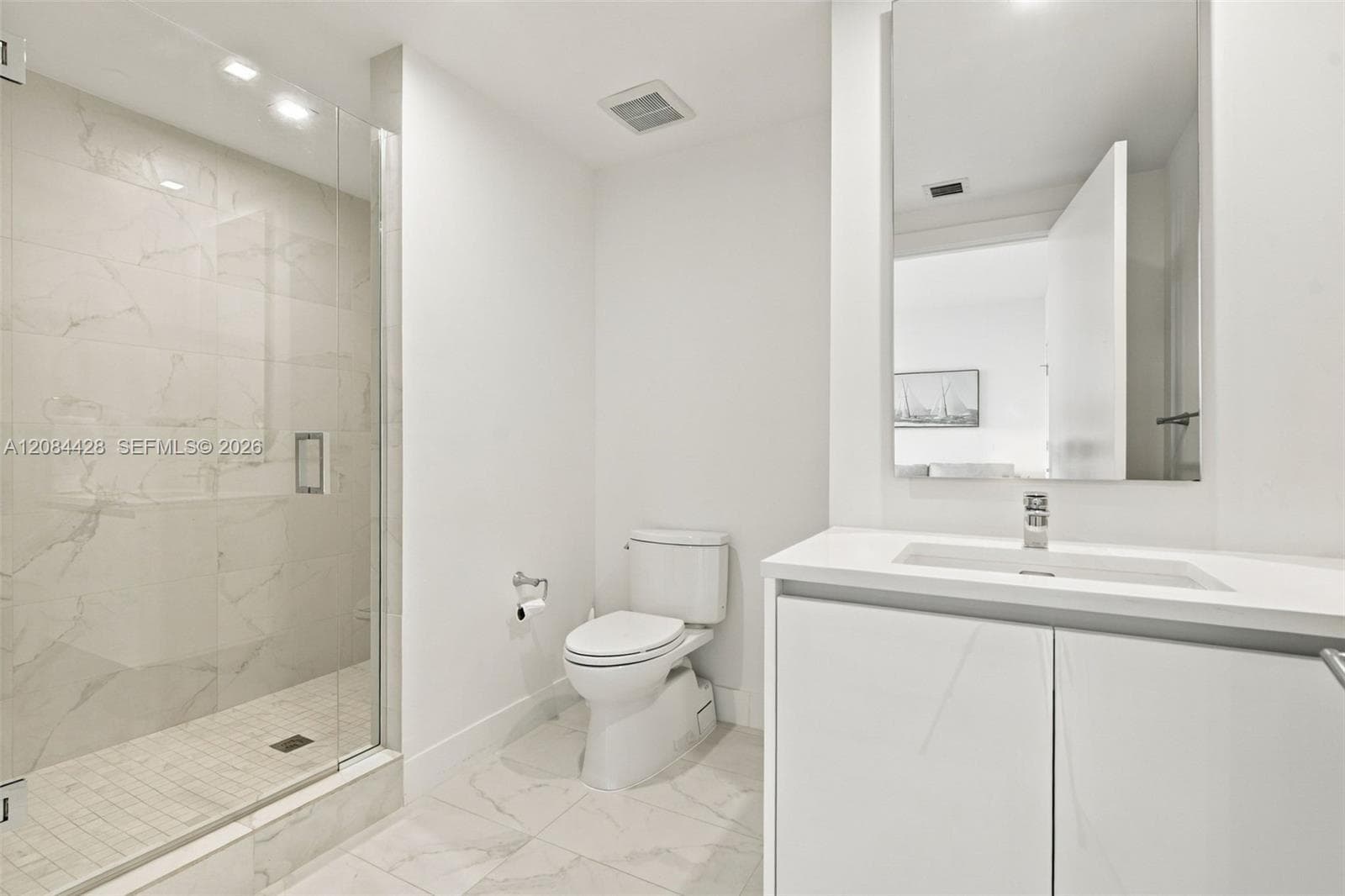 Guest bathroom with a glass-enclosed walk-in shower.