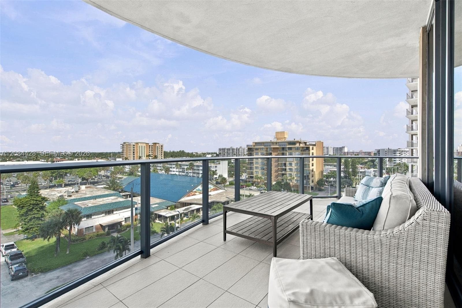 Generous wraparound balcony offering abundant outdoor living space.