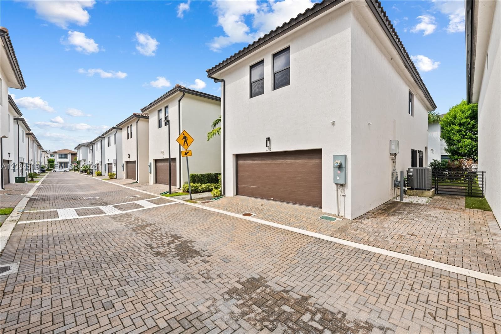 BACK OF THE HOUSE THAT OWNER PAID EXTRA FOR THIS CORNER UNIT WITH A WALKWAY TO FRONT OF HOUSE