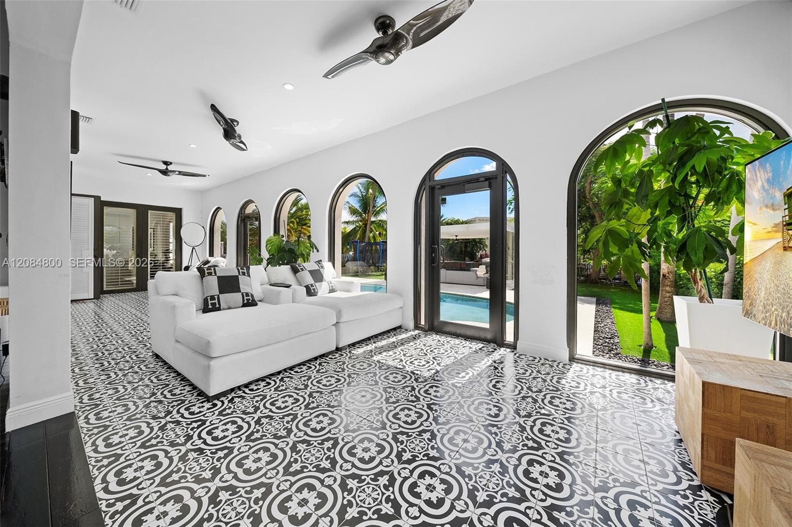 An extended wing provides additional living space with a TV area and separate laundry room
