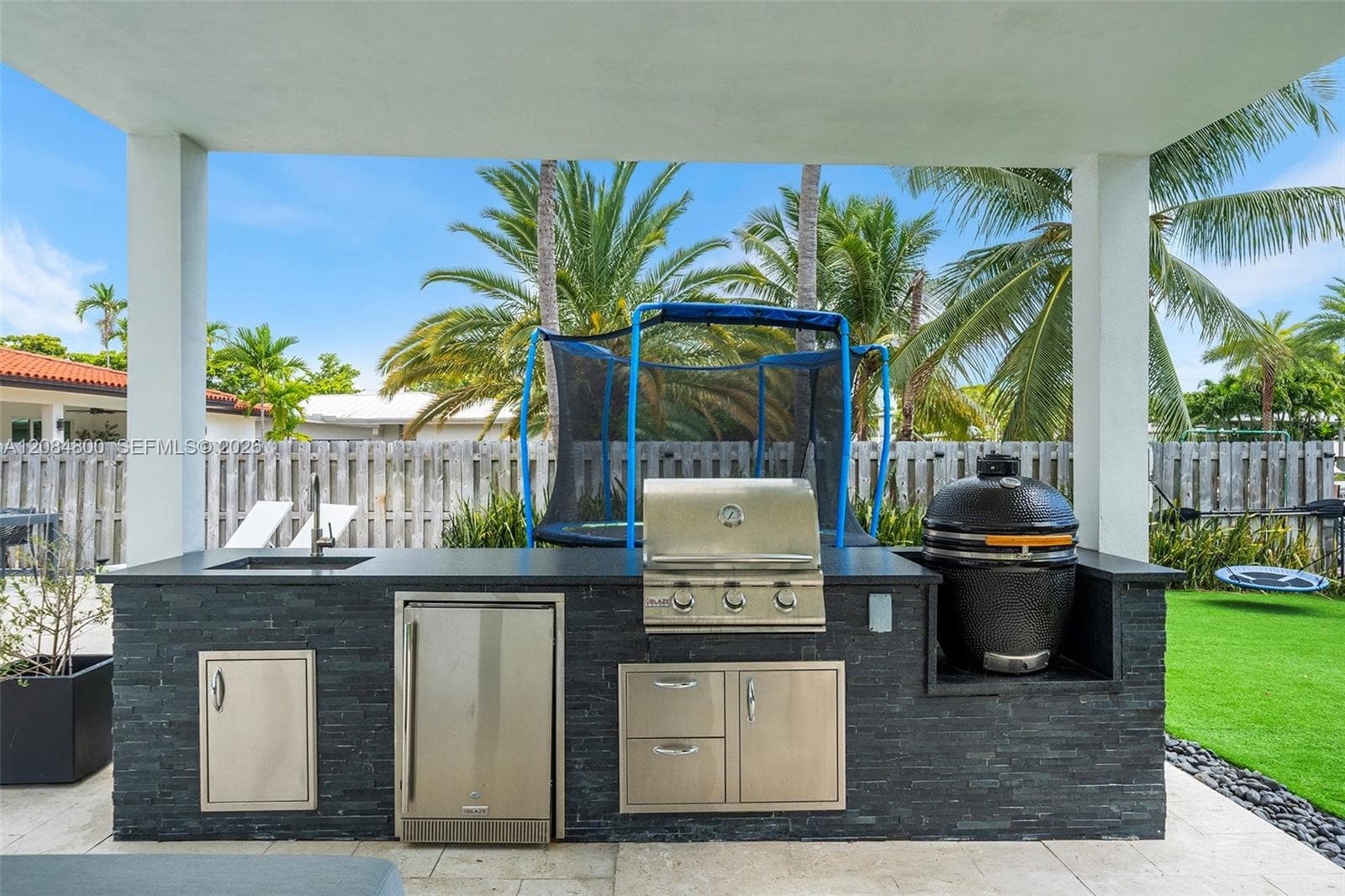 pergola with summer kitchen and lounge area