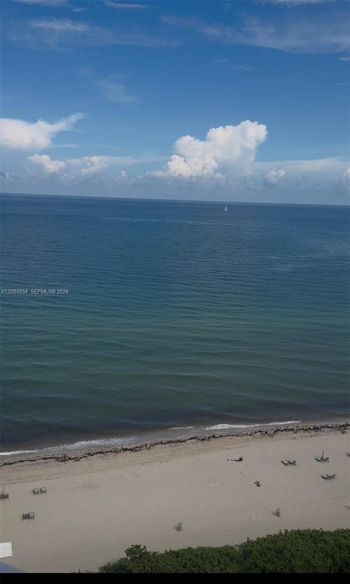 Direct oceanfront exposure featuring an expansive sandy beach and horizon scenery