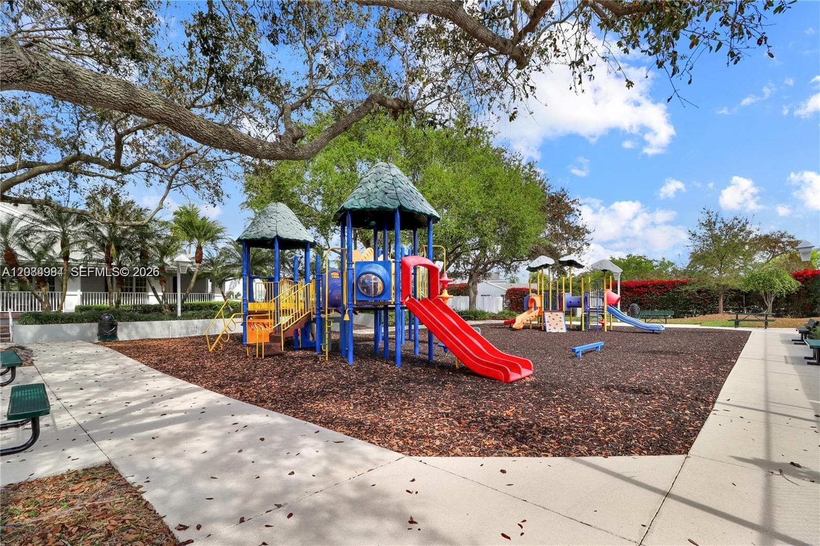 Outdoor playground area set in a shaded community environment.