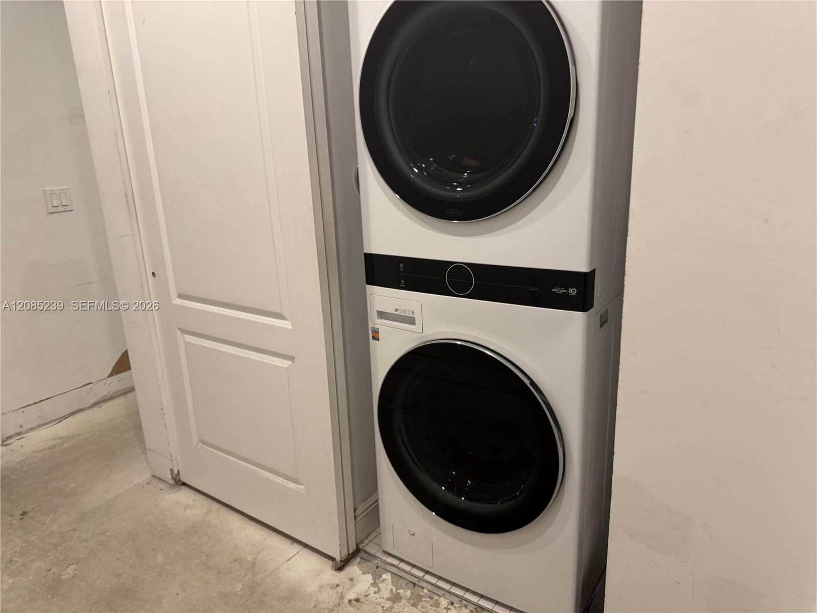 Stacked front-load laundry unit featuring a digital control interface and high-gloss white finish