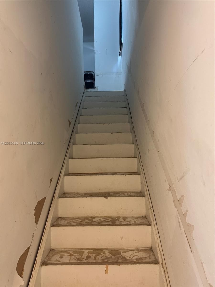 Straight staircase with white painted treads and risers