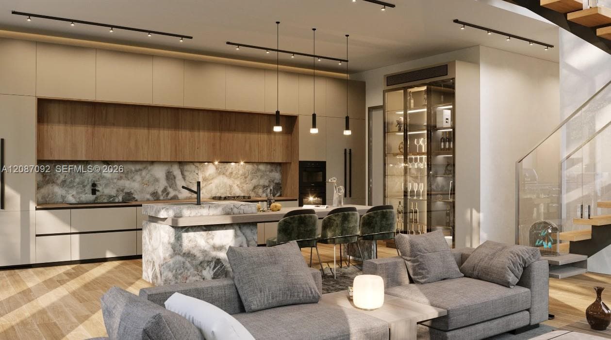 Modern kitchen featuring full-height flat-panel cabinetry, a stone-finished waterfall island, integrated glass-door cabinetry, track lighting, and wood-finish flooring