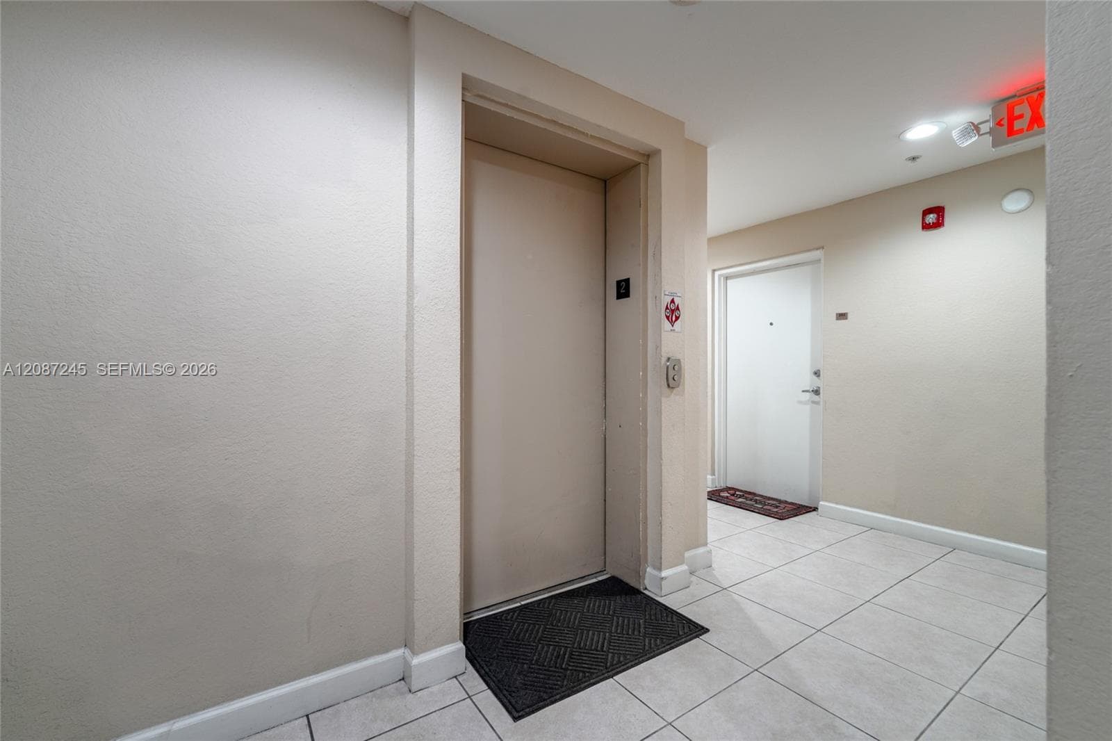 Elevator access with tiled flooring and neutral wall finishes