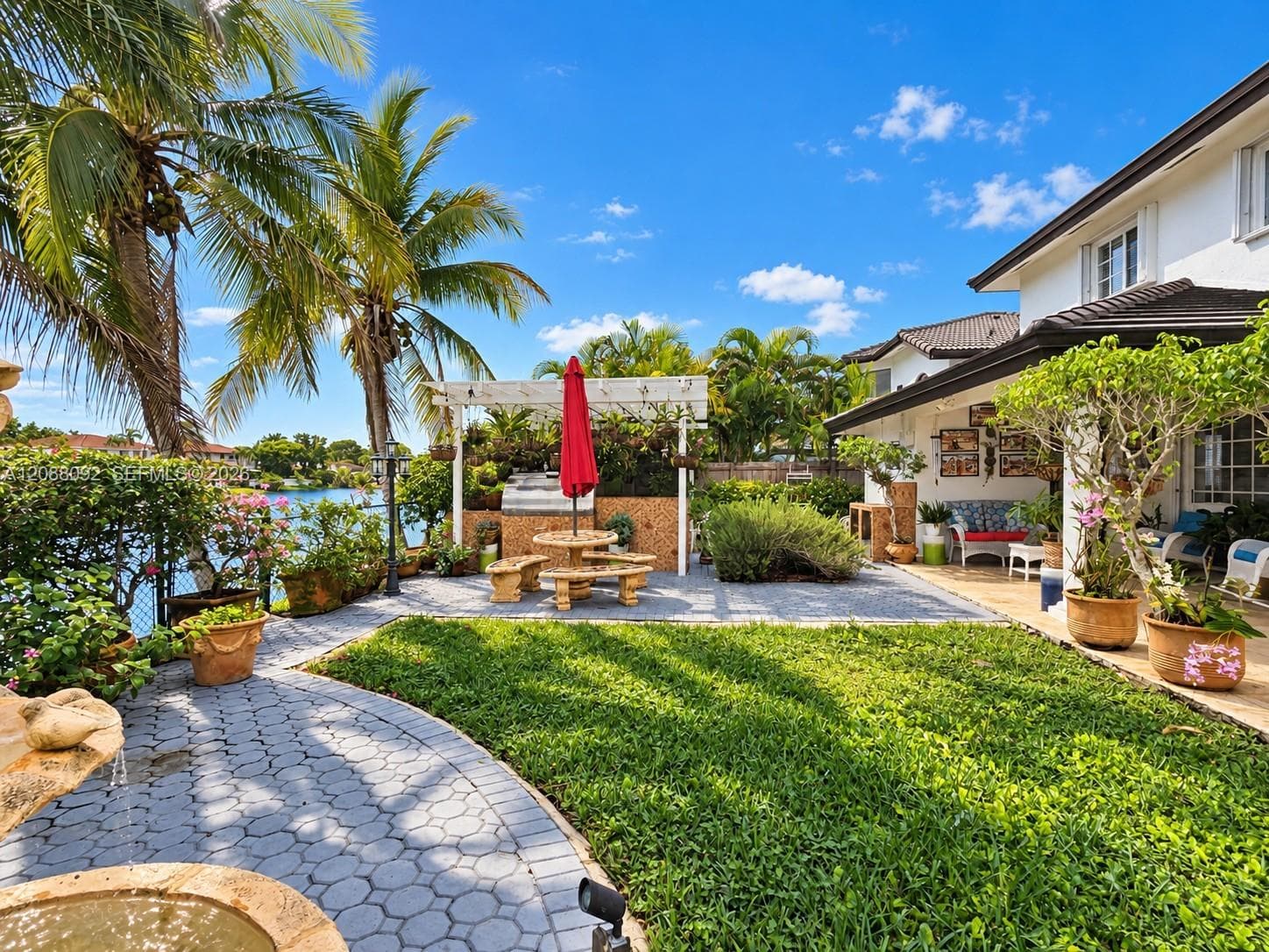 Thoughtfully arranged spaces invite both relaxed entertaining and quiet moments, bringing the beauty and serenity of South Florida living right to your doorstep.