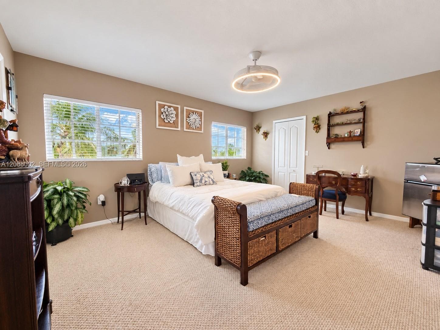 Spacious and filled with natural light, the primary suite offers peaceful lake views framed by lush tropical landscaping and gardens.