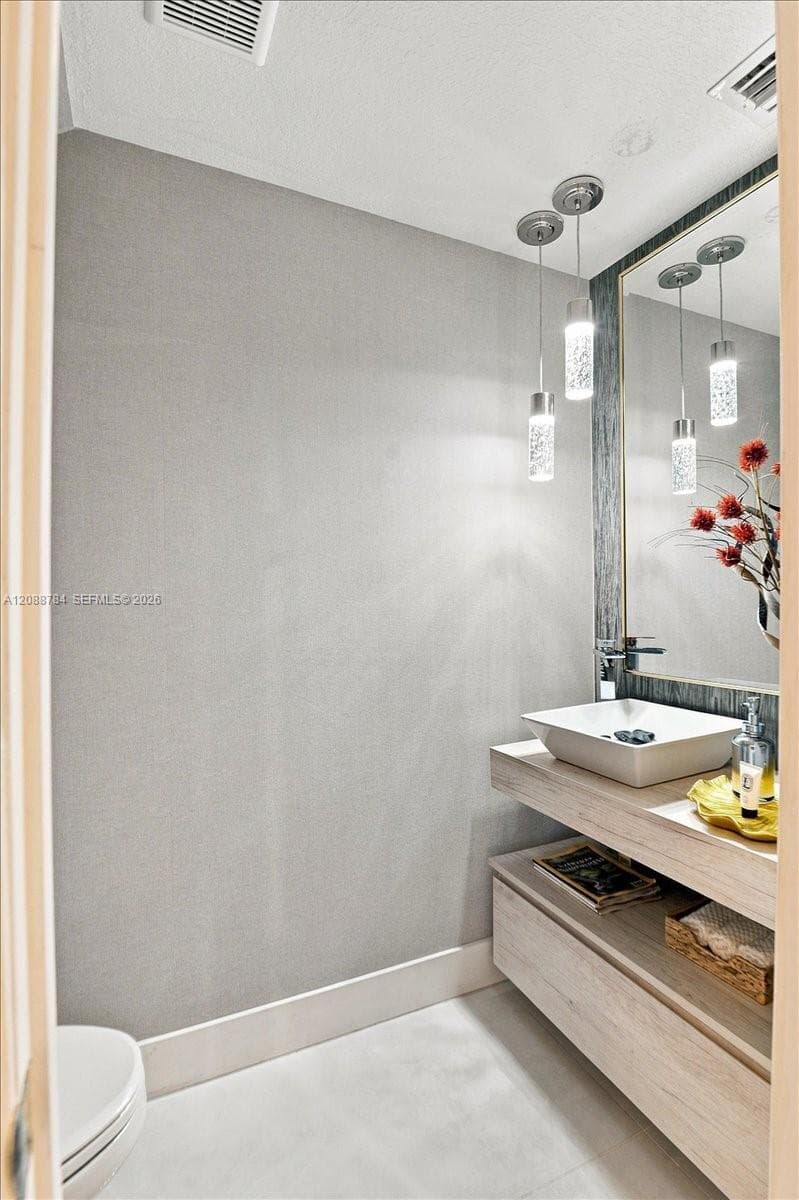 Floating vanity with a vessel sink, single-handle faucet, and integrated wood-finish cabinetry