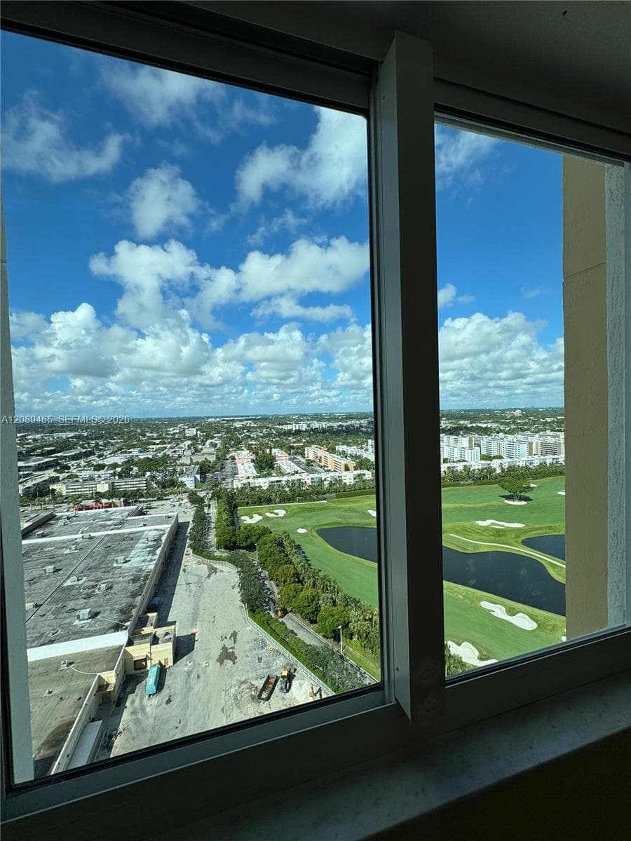 bedroom view  featuring panoramic urban scenery and golf course landscapes