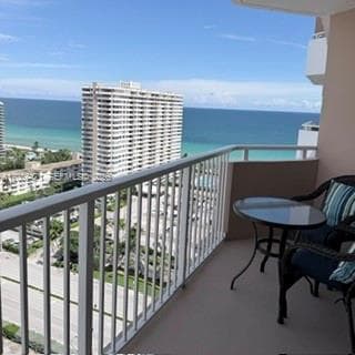 Private balcony featuring metal railings and concrete flooring with ocean and coastal surroundings