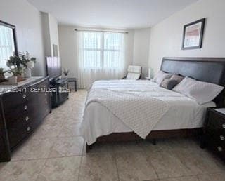 Neutral-toned stone flooring and oversized dual-pane windows with integrated drapery hardware