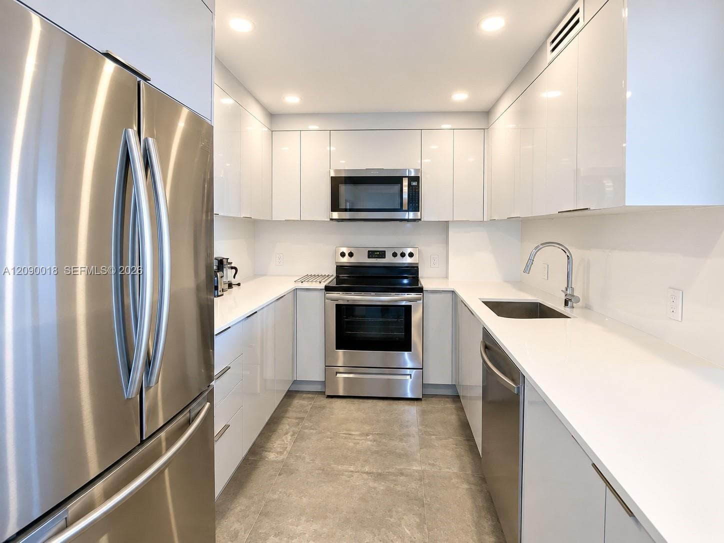 Modern updated kitchen with sleek cabinetry and quartz counter.