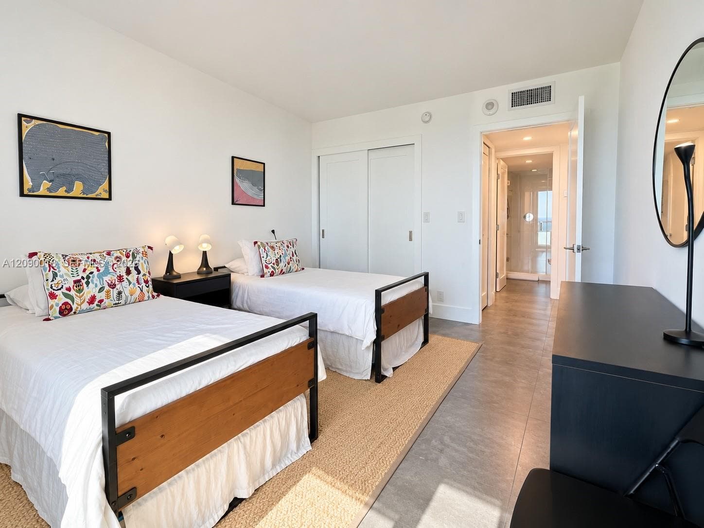 Bright guest room with custom built-in closet storage.