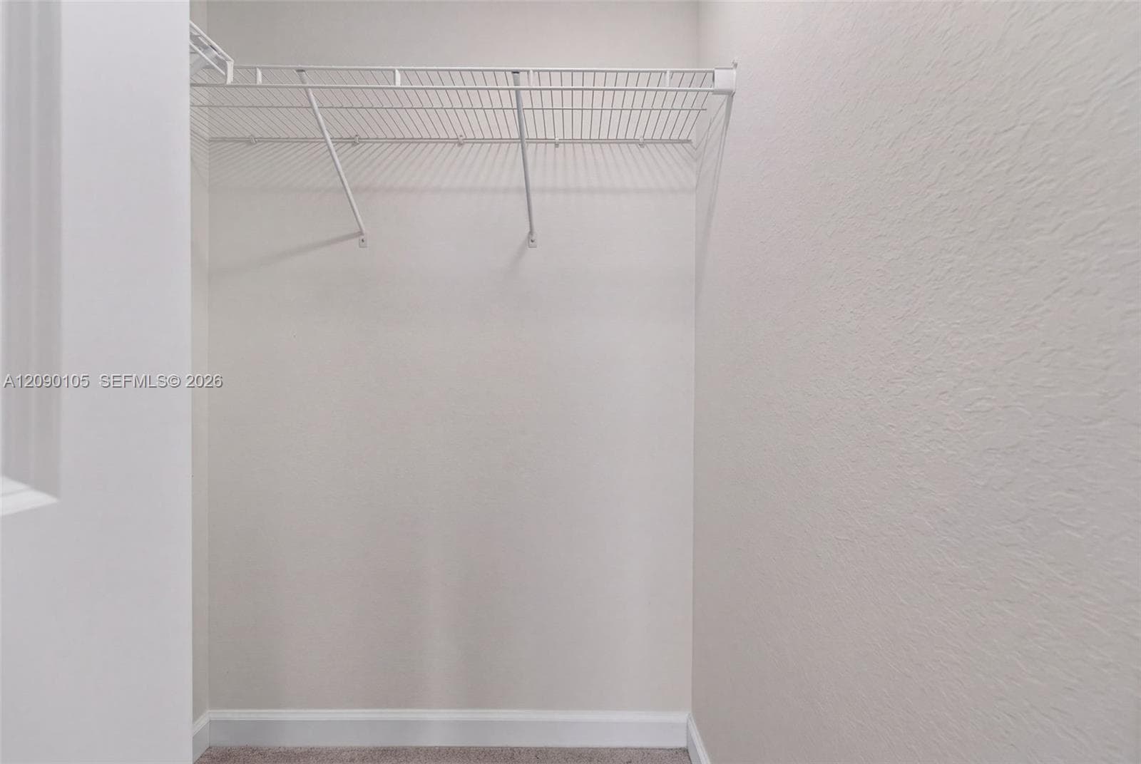 Walk-in closet featuring neutral wall finishes and white wire shelving