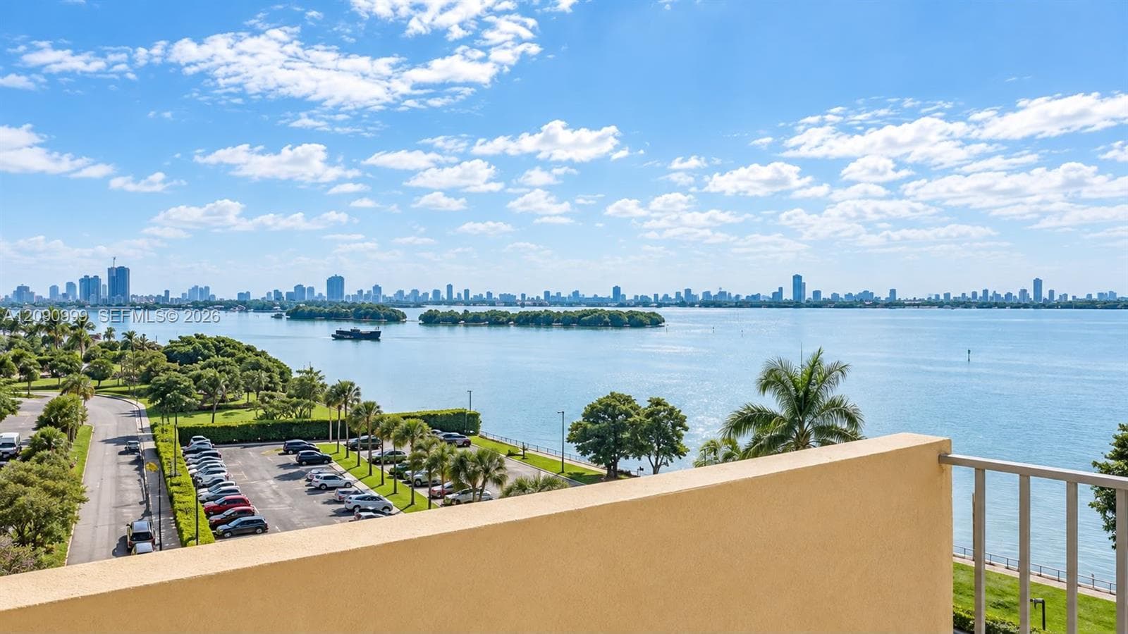 Elevated terrace featuring a metal railing with a panoramic waterfront and cityscape horizon