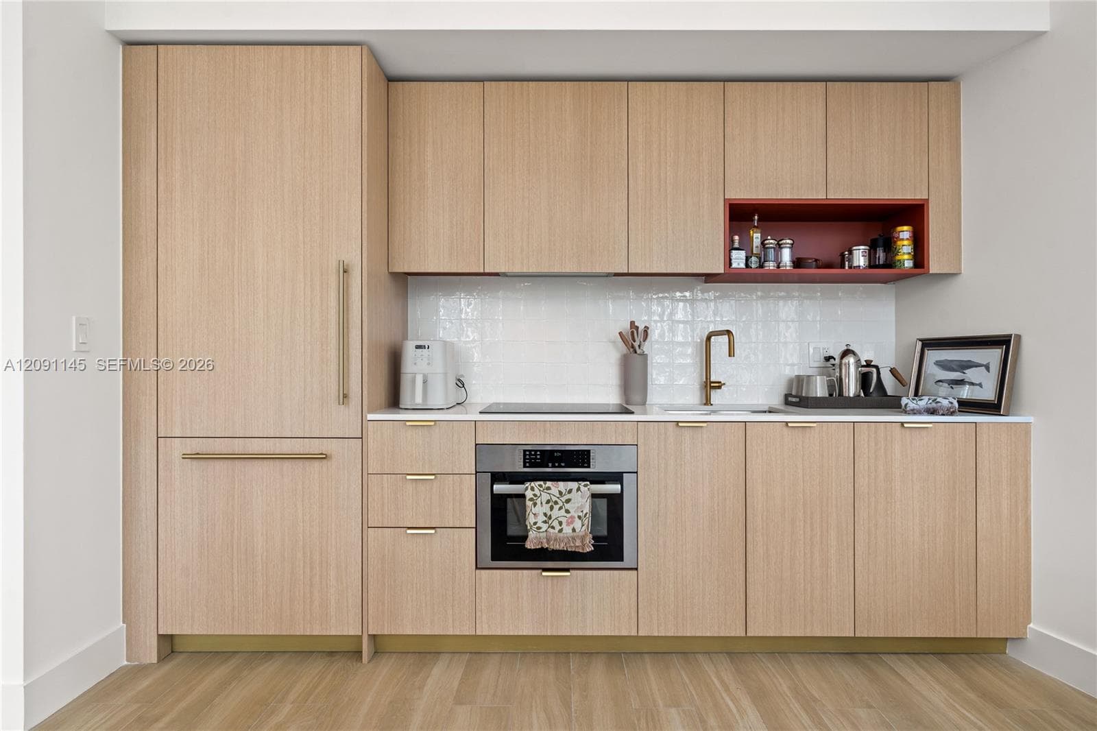 Integrated paneled refrigerator, wood-finish cabinetry, quartz countertops, tile backsplash, and built-in stainless steel oven