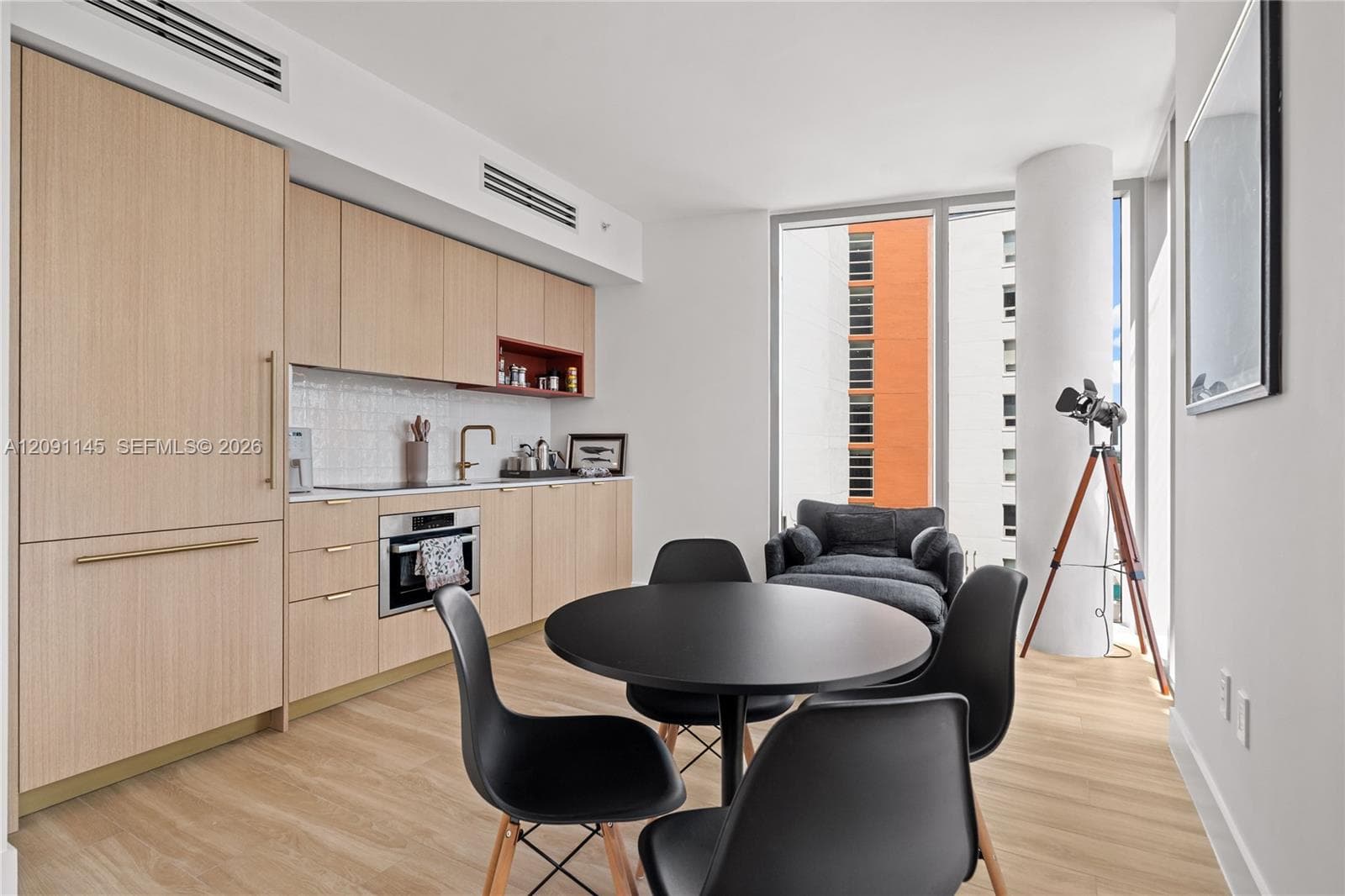 Integrated kitchen with wood-finish cabinetry, built-in appliances, and a tile backsplash