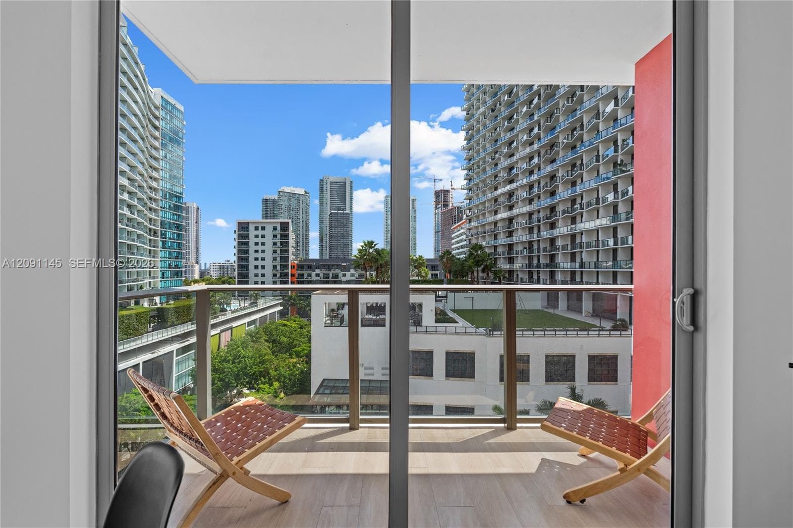 Balcony with glass panel railing and wood-finish flooring