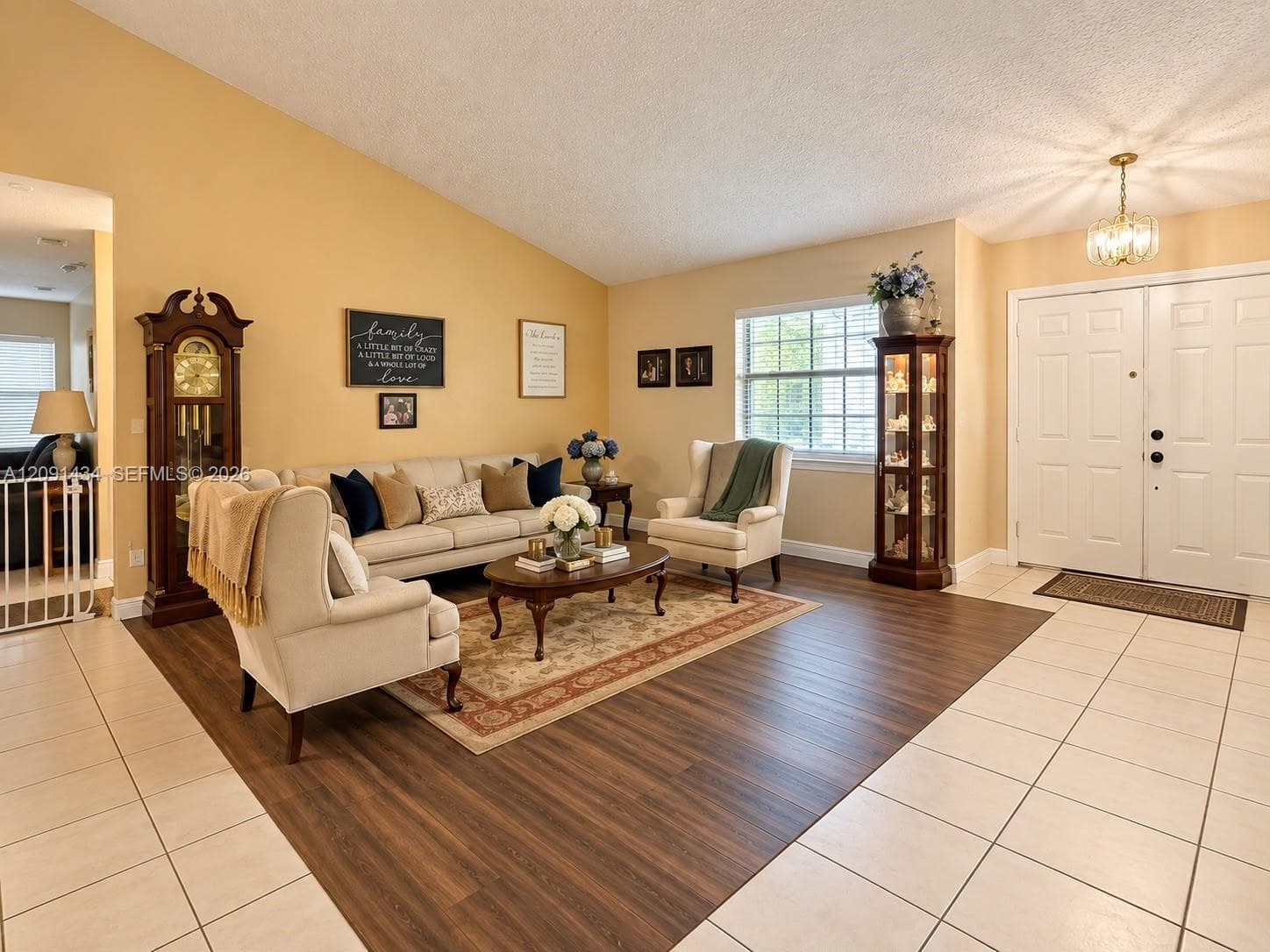 Vaulted ceilings, wood-finish flooring, double-door entryway, recessed lighting, and large window with exterior exposure