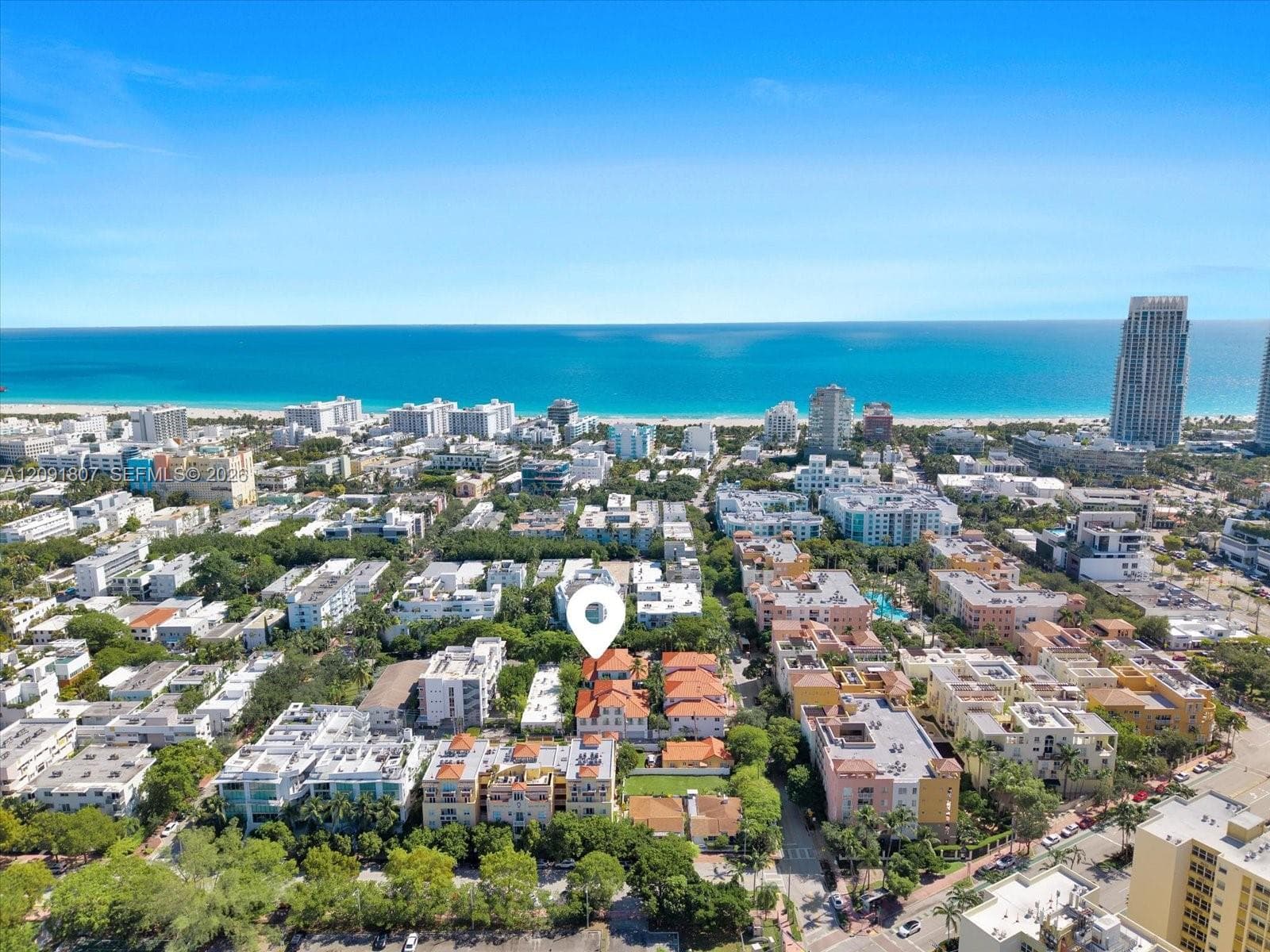 Aerial perspective featuring terracotta-tiled rooflines and proximity to the coastline