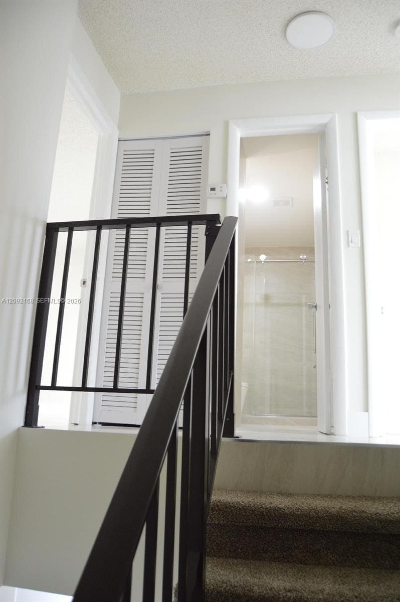 TOP OF THE STAIRS AND VIEW OF THE BATHROOM FOR 2ND AND 3RD BEDROOMS.