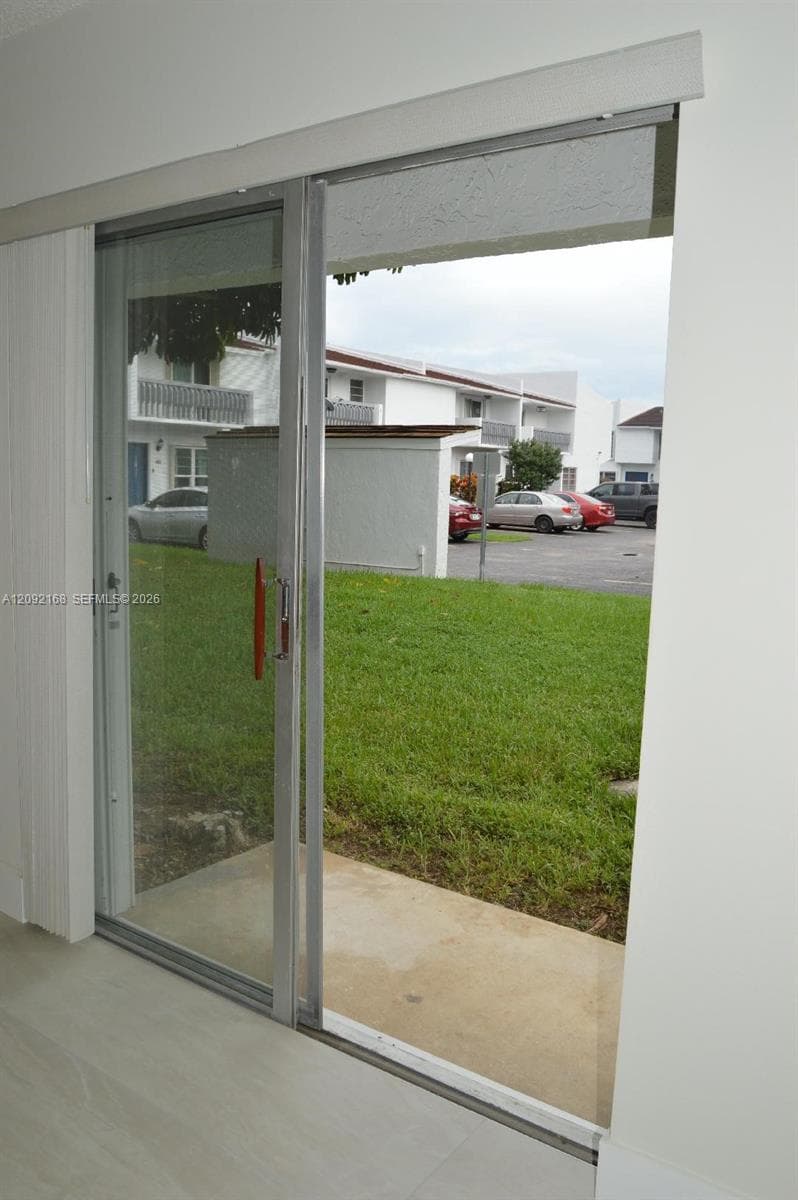 SLIDING DOOR TO BACKYARD FROM FAMILY/DINING ROOM AREA