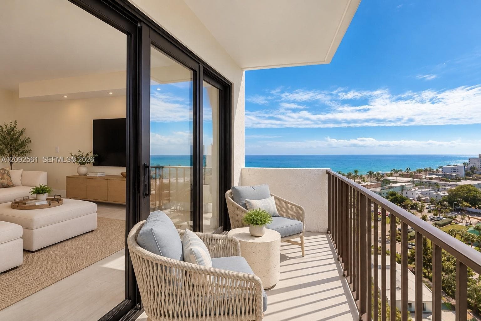 Covered balcony with a metal railing, floor-to-ceiling sliding glass doors, and light-toned flooring