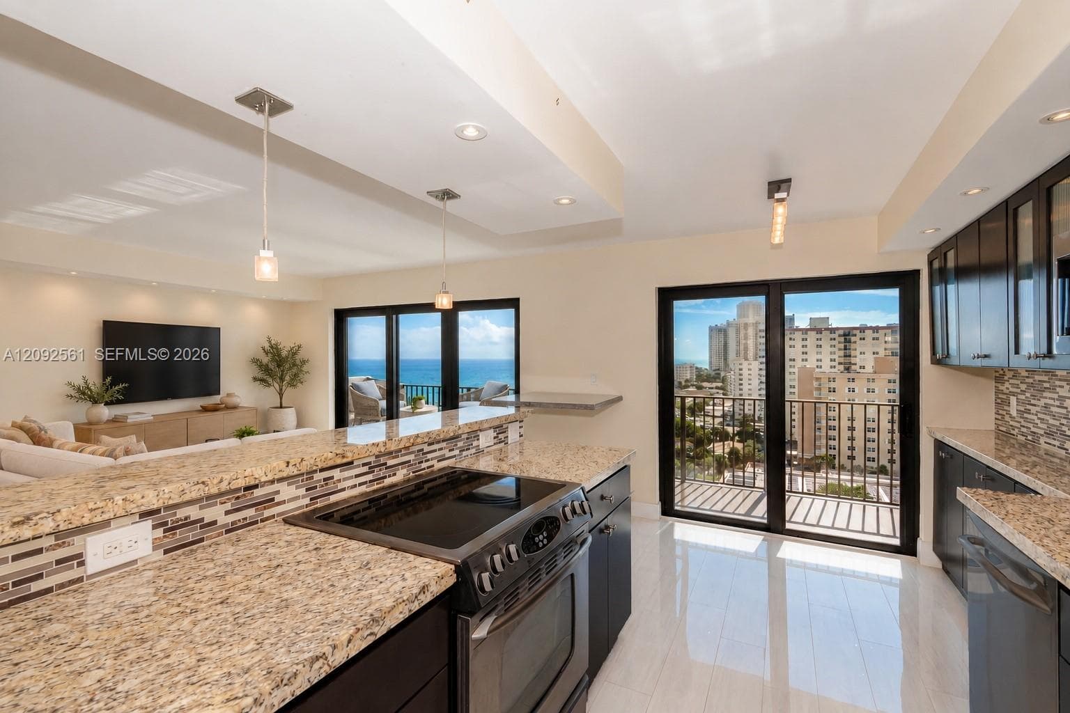 Kitchen featuring dark cabinetry, stone-finish countertops, mosaic tile backsplash, polished flooring, and dual glass sliding doors