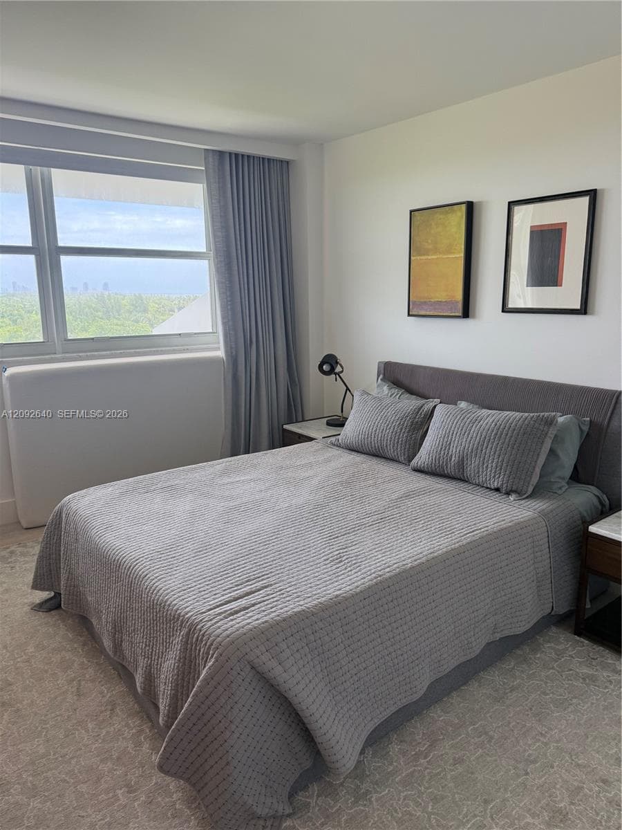 Floor-to-ceiling drapery, large-pane windows, and wall-to-wall carpeting