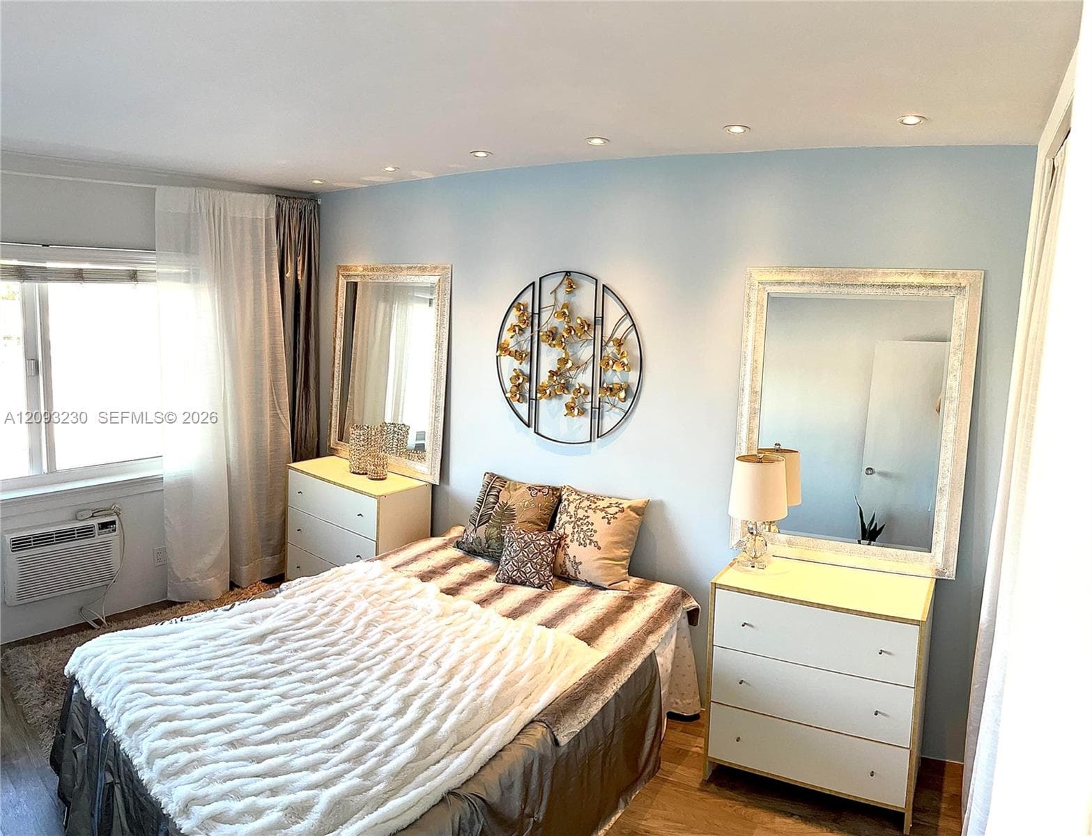 Recessed ceiling lighting with a window unit air conditioner, and wood-finish flooring