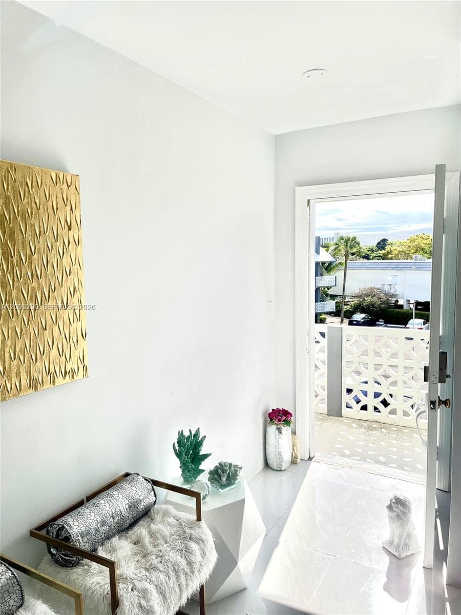 White tile flooring, white walls, and a white framed doorway