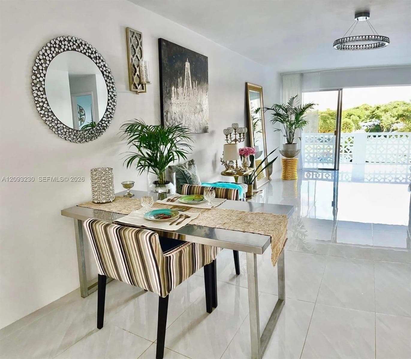 White tile flooring, sliding glass door, decorative exterior wall, and a contemporary ceiling light fixture
