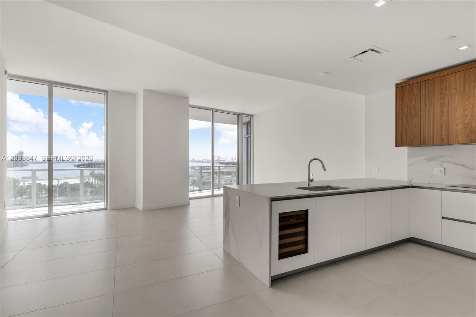 Open living and kitchen layout with 11 foot ceilings and bay views