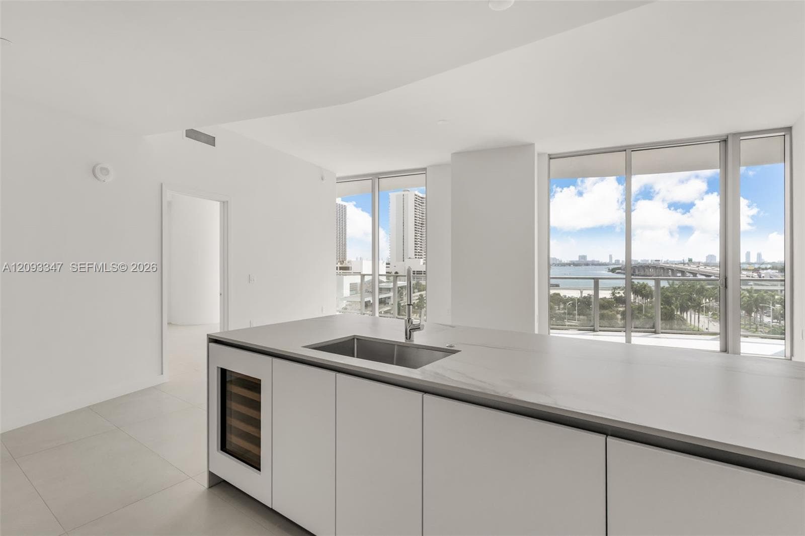 Kitchen island with integrated sink, wine cooler and open bay outlook